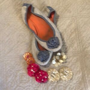 Flat pull on shoes with multiple change out accessories.